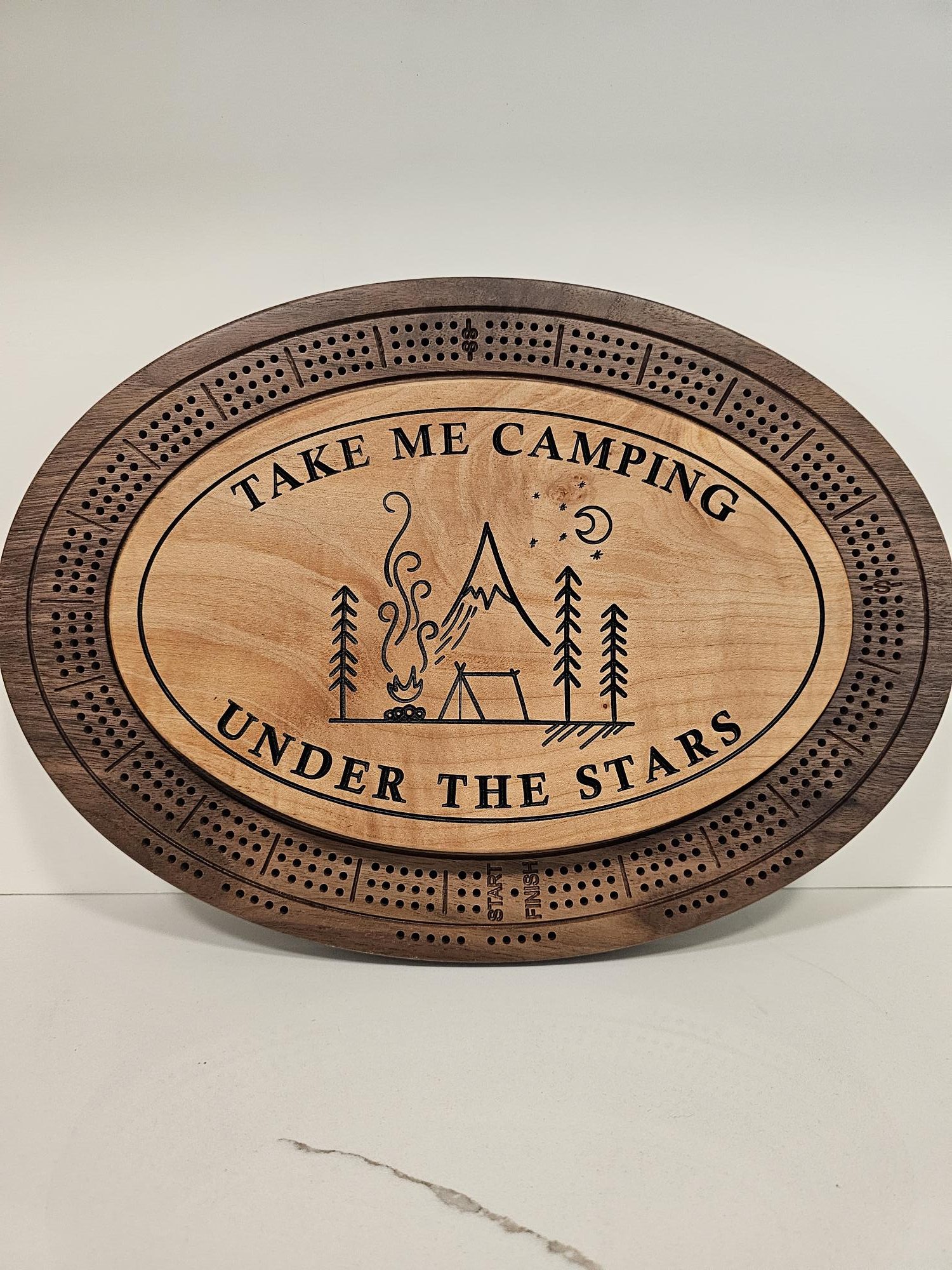 Custom wooden cribbage board with Take Me Camping phrase and outdoor wilderness scene in center